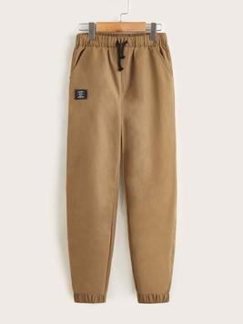 SHEIN Tween Boy Spring And Autumn Mid-Rise Tapered Pants With Drawstring Waist And Patched Design offers at $12 in SheIn