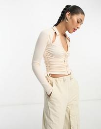 ASOS DESIGN cut out shoulder ruched front shirt in buttermilk offers at $16 in Asos
