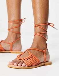 ASOS DESIGN Fizz leather knotted strappy flat sandal in orange offers at $19 in Asos