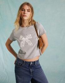 Miss Selfridge short sleeve baby tee with lace bow graphic in gray offers at $14.99 in Asos