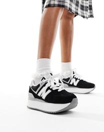 New Balance 574 sneakers in black with white and gray detail offers at $64.99 in Asos
