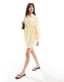 ASOS DESIGN mini shirt dress with ruched sides and pocket detail in buttermilk offers at $44.99 in Asos