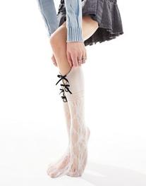 Reclaimed Vintage cut out socks in white with black bows offers at $16.99 in Asos