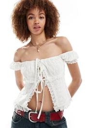 Reclaimed Vintage western bandeau top with bows in white offers at $53.9 in Asos