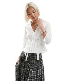 Reclaimed Vintage fitted shirt with frill details in white offers at $59.99 in Asos