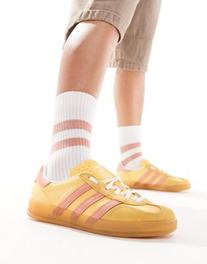 Adidas Originals Gazelle Indoor sneakers in mustard and orange offers at $120 in Asos