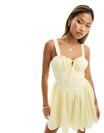 Kaiia milkmaid tie front mini dress in yellow offers at $96 in Asos