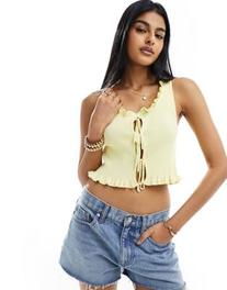 ASOS DESIGN knitted sleeveless lace up tank top in yellow offers at $29.99 in Asos