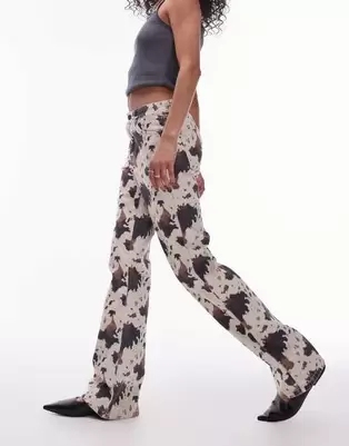 Topshop mid rise 90s flare jeans in cow print offers at $84.99 in Asos