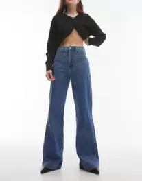 & Other Stories high rise flared jeans with patch pockets in mid blue wash offers at $94 in Asos