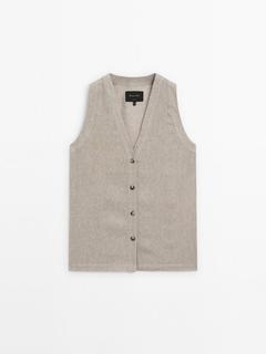 Waffle-knit V-neck vest offers at $149 in Massimo Dutti